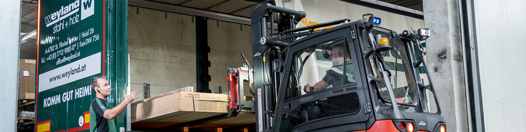 Weyland Logistik Weyland-Mitarbeiter beladen Unternehmens-LKW - Einblicke in Logistik und Transport